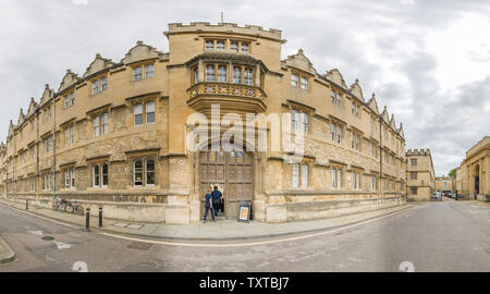 Entrance and exterior facade of Oriel college, Oxford university, along Oriel street on a cloudy summer morning. Stock Photo