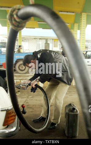 An Iranian driver fuels his car at a gas station in Qazvin, 83 Miles (150 Km) from Tehran, Iran, April 28, 2006. The price of gasoline in Iran is 165 Rials per liter, about seven cents ($.07 USD) per gallon.   (UPI Photo/Mohammad Kheirkhah) Stock Photo