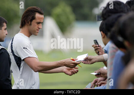 Germany's Bayern Munich player Ali Karimi  and a member of Iran's national team signs autographs for his fans as he attends training camp in Azadi (freedom) sport complex as Iran's national soccer team prepares for World Cup in Germany, in Tehran,  Iran, May 21, 2006. (UPI Photo/Mohammad Kheirkhah) Stock Photo
