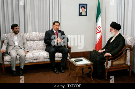 Venezuela's President Hugo Chavez(C) talks with Iran's supreme leader Ayatollah Khamenei (R) as Iran's President Mahmoud Ahmadinejad (L) listen to him during their meeting in Tehran, Iran, on July 29, 2006. A picture of Iran's late supreme leader Rohollah Khomeini is seen on the left.  (UPI Photo/Alireza Sotakbar/ISNA) Stock Photo