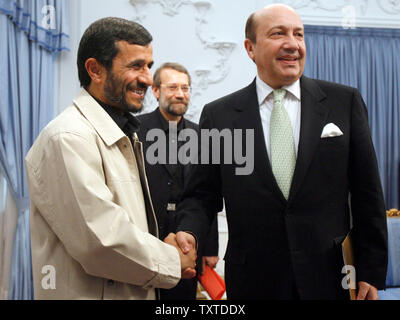 Iranian president Mahmoud Ahmadinejad (L) shakes hand with the Russian Security Council Secretary Igor Ivanov (R) while Iran's chief Nuclear negotiator Ali Larijani (center back) watches on, during a meeting at the presidential palace in Tehran on January 28, 2008. (UPI/Photo) Stock Photo
