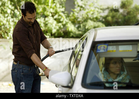 An Iranian driver fuels his car at a gas station in Tehran, Iran on May 23, 2007.  Iran increased the price of gasoline by 25 percent Tuesday, trying to reduce subsidies in a decision likely to deepen dissatisfaction with the government of hard-line President Mahmoud Ahmadinejad.  The price was raised to 38 cents from 30 cents a gallon.  The average price in the United States at this time is approximately $3.18.  (UPI Photo/Mohammad Kheirkhah) Stock Photo