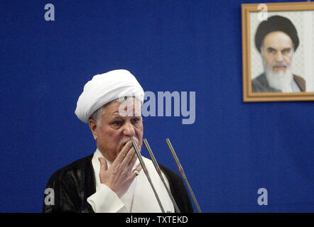 Head of the State Expediency Council and Iran's former President Ali Akbar Hashemi Rafsanjani leads Weekly Friday Prayer at a rally on Al-Quds day (Jerusalem Day) in front of Tehran University campus in Tehran, Iran on October 5, 2007. Jerusalem Day, an annual day of protest decreed in 1979 by the Iran's late revolutionary founder Ayatollah Ruhollah Khomeini , saw people across the Middle East demand that the holy city be returned to Palestinian control. A pictures of Iran's late supreme leader Rohollah Khomeini is seen at right. (UPI Photo/Mohammad Kheirkhah) Stock Photo