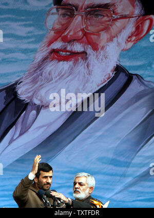 Iran's President Mahmoud Ahmadinejad waves in front of a picture of Iran's supreme leader Ayatollah Ali Khamenei as he attends a rally marking the 29th anniversary of Iran's Islamic Revolution at the Azadi (freedom) Square in Tehran, Iran on February 11, 2008. (UPI Photo/STR) Stock Photo