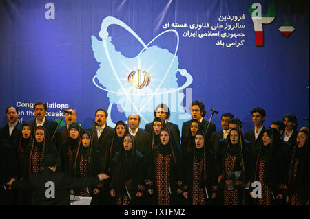 An Iranian music group sings in front of a nuclear sign during a ceremony marking the third anniversary of National Day of Nuclear Technology at international services of the Islamic Republic of Iran Broadcasting (IRIB) conference center in Tehran, Iran on April 8, 2008. President Mahmoud Ahmadinejad announced that Iran started installation of some 6,000 new centrifuges on Tuesday. (UPI Photo/Mohammad Kheirkhah) Stock Photo