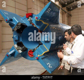 Iran's President Mahmoud Ahmadinejad (2nd R) visits Iran's Safir-e-Omid (ambassador of hope) rocket, which is capable of carrying a satellite into orbit before launch at Iran's space center in Tehran, Iran on August 17, 2008. The Omid program is the first such system designed entirely by Iranian scientists, the report said, adding scientists will launch five additional satellites into orbit by 2010. (UPI Photo/Fars News Agency) Stock Photo