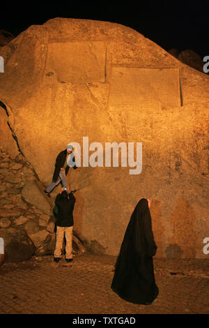 Iranians visit Ganjnameh or Treasure epistle, an ancient inscription on the side of Alvand Mountain, in Hamedan City, 336 km (208 miles) west of Tehran, Iran on November 20, 2008. The inscription, which has been carved in granite, is composed of two sections. One (on the left) ordered by Darius I (521-485 BC) and the other (on the right) ordered by Xerxes I (485-65 BC). Both sections, which have been carved in three ancient languages of Old Persian, Neo-Babylonian and Neo-Elamite, start with praise of God (Ahura Mazda) and describe the lineage and deeds of the mentioned kings. (UPI Photo/Moham Stock Photo