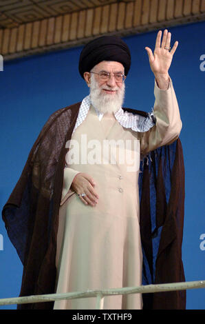 Khamenei Smiling Supporters of Iran’s Supreme Leader Ayatollah Ali Khamenei sit under ...