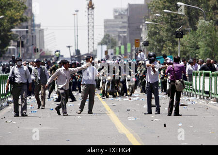 Members of a pro-government Basij militia and anti-riot police are seen in Enghelab or Revolution Street during a clash after Chairman of the Experts Assembly and Iran's former President Ali Akbar Hashemi Rafsanjani delivered his speech during Friday Prayer at Tehran University campus in Iran, on July 17, 2009. Rafsanjani said on Friday Iran was in a 'crisis' after last month's disputed election. (UPI Photo) Stock Photo