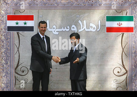 Iranian President Mahmoud Ahmadinejad greets his Syrian counterpart Bashar al-Assad on August 19, 2009 at the presidential palace in Tehran , Iran .      UPI/Maryam Rahmaniani Stock Photo