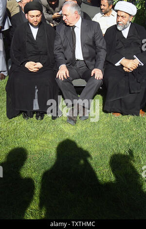 The son of Abdul Aaziz al-Hakim, Ammar al-Hakim (L), speaks with Iraqi Shiite Muslim politician Ahmed Chalabi (M) during funeral for Abdul Aziz al-Hakim  in Tehran, Iran on Aug 27, 2009.  Abdul Aaziz al-Hakim was the leader of the pro-Iranian Supreme Islamic Iraqi Council in Iraq, and rose to power after the U.S.-led invasion of Iraq in 2003.  He died of lung cancer.       UPI/Maryam Rahmanian Stock Photo