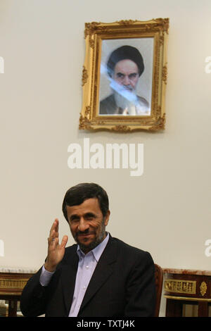 Iranian President Mahmoud Ahmadinejad sits below the picture of Iran's late leader Ayatolah Khomeini during meeting with Mauritanian President Mohamed Ould Abdel Aziz  at the presidential place in Tehran,Iran on January 26,2010.     UPI/Maryam Rahmanian Stock Photo