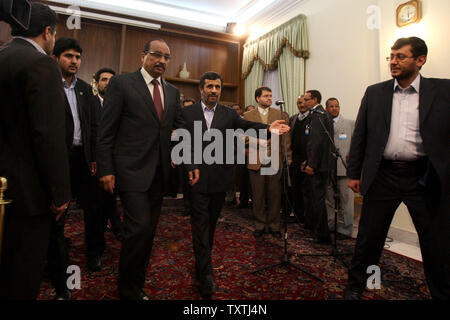 Iranian President Mahmoud Ahmadinejad (C) enters a press conference with  Mauritanian President Mohamed Ould Abdel Aziz at the presidential place in Tehran,Iran on January 26, 2010.     UPI/Maryam Rahmanian Stock Photo