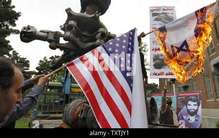 Members of the Basij organization burn an Israel flag during a ceremony marking the 31st anniversary of a failed US ''rescue'' operation in 1980, inside of the former US embassy in Tehran, Iran on April 25, 2011 .      UPI/Maryam Rahmanian Stock Photo