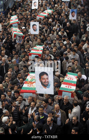 Iranians carry the flag draped coffins containing the remains of a  Revolutionary Guard soldiers  who were killed in explosion in Bidegeneh village, about 35 Kilometers (21 miles) west of Tehran. The explosion happened on Saturday when  a munitions depot caught fire at the IRGC base in Bidgeneh village. The Total of 17 IRGC forces, including Maj. Gen. Hassan Tehrani Moqaddam, director of the Guard's Jihad Self-Sufficiency Organization were killed and 16 others were seriously injured. Tehran, Iran , November 14, 2011.     UPI/Maryam Rahmanian. Stock Photo