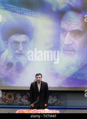 Iranian President Mahmoud Ahmadinejad  stands in front of the pictures of Iran's current Leader Ayatollah Khamenei (L) and Iran's late leader Ayatollah Khomeini (R) as he listens to Iranian national anthem before his press conference started in presidential palace in Tehran, Iran on October 2, 2012.    UPI/Maryam Rahmanian Stock Photo