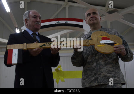 US Brigadier General David Quantock (R) hands Iraqi Minister of Justice Dara Nur al-Din a symbolic wooden key to Taji prison, a 107-million-dollar compound that can hold up to 5,600 prisoners and is located about 25 kilometres (15 miles) north of Baghdad, during a ceremony to transfer control of one of the US' two remaining detention facilities to Iraqi authorities on March 15, 2010.   UPI/Ali Jasim Stock Photo
