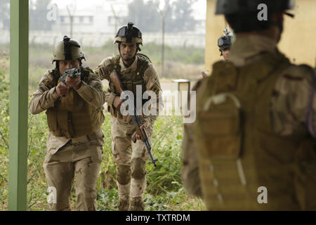 Iraqi soldiers with the 4th Battalion, 23rd Iraqi Army Brigade, move in to detain a notional enemy soldier during a skills evaluation at Camp Taji, Iraq, on March 28, 2016. Task Group Taji conducted the skills evaluation to gauge the soldiersÕ proficiency in basic combat tasks. Through advise and assist, and building partner capacity missions, the Combined Joint Task Force C Operation Inherent ResolveÕs multinational coalition has trained more than 19.9K personnel to defeat the Islamic State of Iraq and the Levant. Photo by Sgt. Paul Sale/U.S. Army/UPI Stock Photo