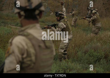 An Iraqi soldier with the 4th Battalion, 23rd Iraqi Army Brigade, calls his squad to a halt during a simulated patrol for a skills evaluation at Camp Taji, Iraq, on March 28, 2016. Task Group Taji conducted the skills evaluation to gauge the soldiersÕ proficiency in basic combat tasks. Through advise and assist, and building partner capacity missions, the Combined Joint Task Force C Operation Inherent ResolveÕs multinational coalition has trained more than 19.9K personnel to defeat the Islamic State of Iraq and the Levant. Photo by Sgt. Paul Sale/U.S. Army/UPI Stock Photo