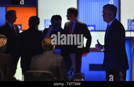 2016 Republican presidential candidate former Florida Gov. Jeb Bush (R) gives a thumbs up as he waits with the stage lights off for the GOP debate to be resumed after a break, January 28, 2016, in Des Moines, Iowa. Billionaire businessman Donald J. Trump has boycotted the debate, which is the final one before Iowa's first-in-the-nation caucuses, February 1.      Photo by Mike Theiler/UPI Stock Photo