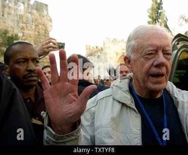 Former US President Jimmy Carter leaves  a polling station  inside the Jaffa Gate in the Old City, East Jerusalem, January 9, 2005. Carter is the co-leader  of the delegation to observe and monitor the Palestinian Presidential election. Mahmoud Abbas is expected to win the election as Palestinians cast their vote to elect a successor to the late Palestinian leader Yasser Arafat. (UPI Photo/Debbie Hill) Stock Photo