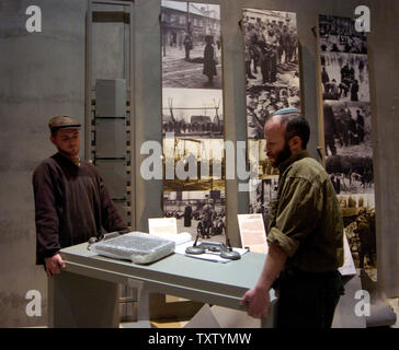 Workers set up a display in the New History Museum at Yad Vashem Holocaust Museum in Jerusalem, February 13, 2005. The new 4,2000 square meter museum cost $40 million dollars and will open March 15. The story of the Holocaust will be illustrated with authentic  artifacts,personal objects, and share individual experiences. (UPI Photo/Debbie Hill) Stock Photo