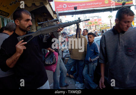 A Palestinian vendor sells toy guns to Palestinians preparing to celebrate Eid-al-Fitr, which marks the end of the holy month of Ramadan, in the West Bank city, Ramallah, November 1, 2005. Eid-al-Fitr is the largest Muslim festival held at the end of the month of fasting and prayer, and will start on Wednesday or Thursday, depending on the sighting of the moon. (UPI Photo/Debbie Hill) Stock Photo