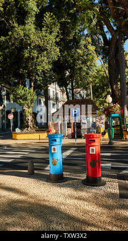 Red and blue postboxes in front of the Municiple garden Funchal in the Old Town, Madeira, Portugal, European Union Stock Photo