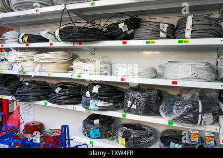 Chelyabinsk Region, Russia - June 2019. Electrical goods store. Rack with goods. Rolls of electrical cables in the store. Cables for electricity sold Stock Photo