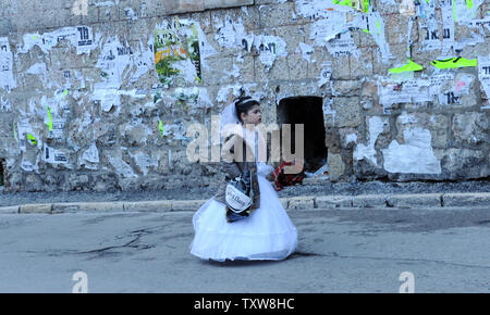 An Ultra-Orthodox girl  wears a Queen Esther costume on the Jewish holiday of Purim in Mea Shearim, Jerusalem, March 1, 2010. Purim is the celebration of the salvation of the Jews from genocide in ancient Persia as told in the book of Esther. UPI/Debbie Hill Stock Photo