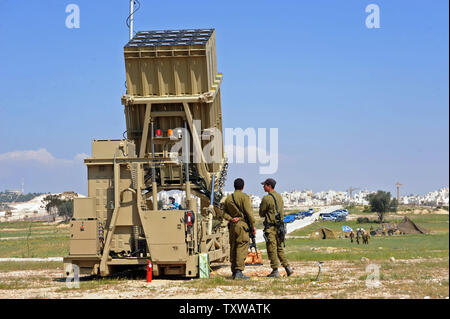 Israeli soldiers stand near the Iron Dome, a new anti-rocket system, stationed near the southern city of Beersheba, Israel, March 27, 2011. The Israeli Defense Force deployed the $200 million Iron Dome system in response to dozens of rockets fired by Palestinian militants from Gaza in the past weeks. The Iron Dome is meant to protect Israeli towns from rockets fired from Gaza.   UPI/Debbie Hill Stock Photo