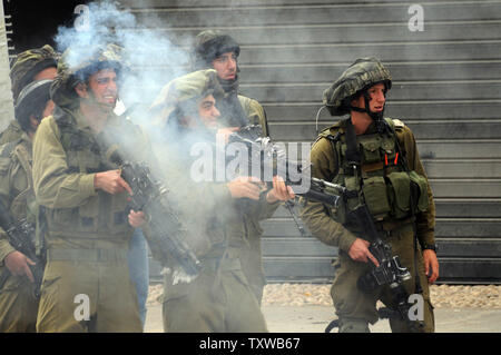 Israeli soldiers fire tear gas during clashes stone throwing Palestinians, not seen, on the 63rd anniversary of 'Nakba', Arabic for 'Catastrophe', the term used to mark events leading to the founding of Israel, May 15, 2011.  Nakba Day is the annual day of protests by Palestinians marking the creation of the State of Israel in 1948. UPI/Debbie Hill Stock Photo