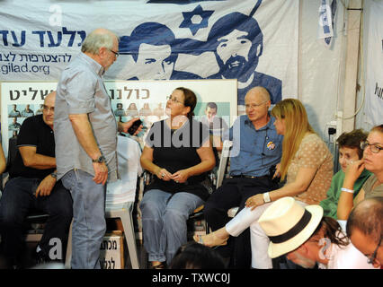 Aviva and Noam Shalit, parents of captured Israeli soldier Gilad Shalit, whose portrait hangs in the background, sit in a protest tent set up outside Israeli  Prime Minister Benjamin Netanyahu's residence in Jerusalem, October 11, 2011. Israel and Hamas have reached a deal to free Shalit, held by Hamas-linked militants in the Gaza Strip since June 25, 2006, in exchange for a thousand Palestinian prisoners, officials on both sides say.   UPI/Debbie Hill Stock Photo