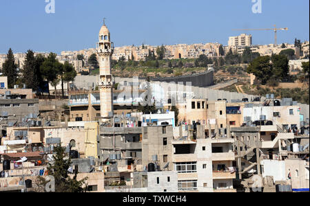 A minaret looms above the controversial Israeli separation barrier that surrounds the Aida Refugee Camp in Bethlehem, West Bank. February 5, 2012. Palestinian President Mahmoud Abbas met with Hamas head Khaled Mashaal in Doha, Qatar, on Sunday, to advance the implementation of a reconciliation agreement between rival Palestinian factions Fatah and Hamas. UPI/Debbie Hill Stock Photo