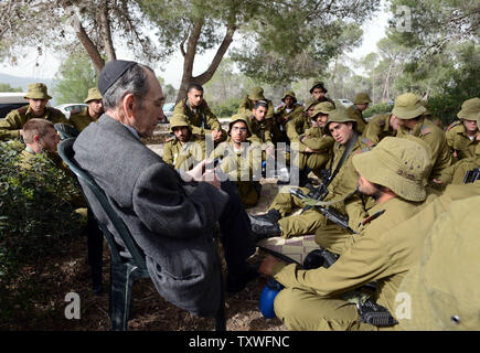 Holocaust survivor Meir Friedmann, 87, shares his personal testimony with Israeli combat soldiers during a Holocaust commemoration event on Holocaust Martyrs' and Heroes' Remembrance Day, in the Martyr's Forest 'Scroll of Fire', outside of Jerusalem, Israel, April 8, 2013.  UPI/Debbie Hill Stock Photo