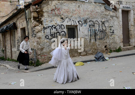 An Ultra-Orthodox Jewish girl wears a bride costume on the feast of Purim in Mea Shearim in Jerusalem, Israel, March 17, 2014. The Purim holiday commemorates the deliverance of the Jewish people from genocide in ancient Persia, as recounted in the book of Esther.  UPI/Debbie Hill.. Stock Photo