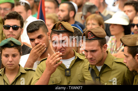 Israeli soldiers weep during the funeral of American-Israeli soldier Max Steinberg, 24, in the military cemetery on Mt. Herzl in Jerusalem, Israel, July 23, 2014.  Steinberg, a native of Los Angeles, California, immigrated to Israel and enlisted in the Israel Defense Forces in 2012, where he served as a sharpshooter in the elite Golani Brigade. He was among the 13 soldiers killed by Palestinian militants in the Gaza Strip on Sunday. Twenty-nine Israeli troops have been killed since the army launched a ground incursion into Gaza last week. More than 30,000 people attended the funeral. UPI/Debbi Stock Photo