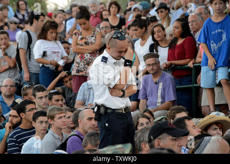 An Israeli cries during the military funeral of  Staff Sgt. Barkai Yishai Shor, 21, in the Mt. Herzl cemetery in Jerusalem, Israel, July 29, 2014. Shor was killed yesterday when Palestinian terrorist entered Israel through a tunnel from Gaza.  UPI/Debbie Hill Stock Photo