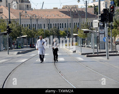 Ultra-Orthodox Jews walk on empty streets on Yom Kippur, the holiest day in the Jewish year, in Jerusalem, Israel, October 4, 2014. Israel comes to a standstill for twenty-five hours on Yom Kippur as Jews fast and pray on the Day of Atonement.  UPI/Debbie Hill Stock Photo
