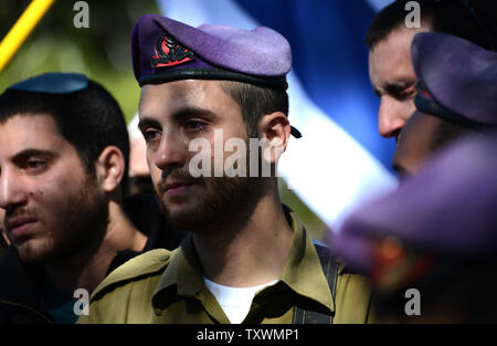 Israeli soldiers weep during the funeral of Major Yochai Kalangel, 25, at the Mt. Herzl Military Cemetery in Jerusalem, Israel, January 29, 2015. Kalangel was one of two soldiers killed by Lebanon's Hezbollah militants yesterday, when  an anti-tank missile struck an Israel Defense vehicle on patrol near the border with Lebanon in northern Israel. He leaves behind a wife and a one year old daughter. Photo by Debbie Hill/UPI Stock Photo