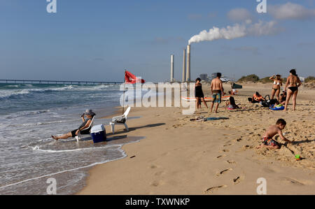 Israeli enjoy the beach at Zikim, Israel, near the Israel-Gaza border, July 6, 2015. A year after the Gaza War, the residents of Israel's southern communities near the Gaza border have become accustomed to living with concrete walls and bomb shelters to protect against rockets and mortars fired from Hamas ruled Gaza.  Photo by Debbie Hill/UPI Stock Photo
