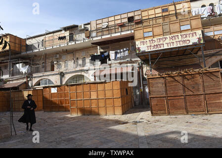 An Ultra-Orthodox Jews walks in a courtyard with numerous Sukkah, temporary huts, for the Jewish feast of Sukkot, the Feast of Tabernacles, in Mea Shearim, Jerusalem, September 24, 2015. The weeklong Sukkot holidays begins at sunset September 27 and commemorates the exodus of the Israelites from Egypt and their wandering in the desert for 40 years. Temporary huts, or Sukkahs, are built outside the houses where meals are eaters and religious Jews sleep during the holiday.    Photo by Debbie Hill/ UPI Stock Photo