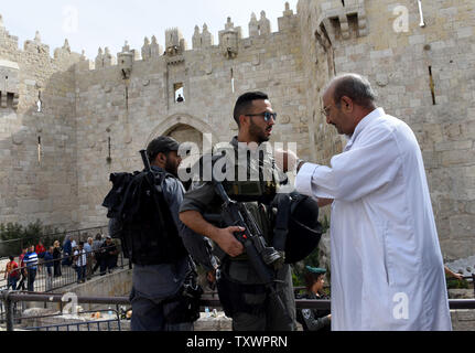 A Palestinian argues with an Israeli border police ahead of Muslim Friday prayers outside the Damascus Gate in the east Jerusalem, October 23, 2015. For the first time in several weeks of violence, Israel did not limit the age of Muslims who could enter the Al-Aqsa Mosque Compound to pray in an attempt to ease tensions with the Palestinians.  Photo by Debbie Hill/ UPI Stock Photo