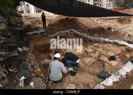 Workers from the Israeli Antiquities Authority excavates an 1,6000 years old Roman Bathhouse from the 4th or 5th century CE, that was uncovered in the Schneller Compound in Jerusalem, Israel, March 2, 2016. The bathhouse was discovered prior to construction of residential buildings for the Ultra-Orthodox Jewish population. The bathhouse includes terra cotta pipes used to heat the bathhouse and several clay bricks, some which were stamped with the name of the Tenth Roman Legion, which participated in the conquest of Jewish Jerusalem. A large winery dating to the Roman or Byzantine period was un Stock Photo