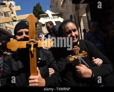 Orthodox Christian pilgrims carry crosses along the Via Dolorosa ...