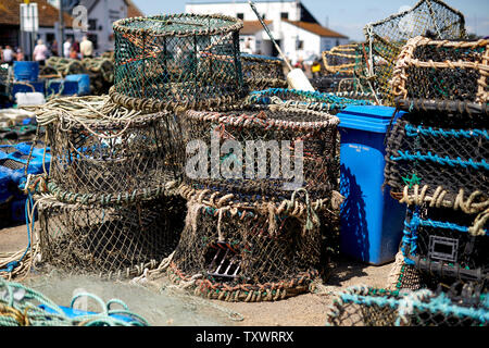 Fishing tackle and lobster pots on the harbour at Mudeford Quay, Dorset. Part of the British fishing industry. Stock Photo