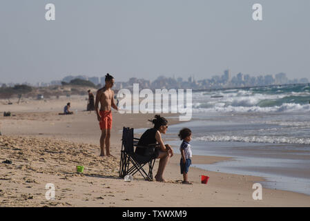 Israelis enjoy the beach on the Mediterranean Sea near Kibbutz Zikim, on the Israeli-Gaza border, June 22, 2017.  This week Israeli's National Electric Company cut it's limited electricity supply to the Gaza Strip after the Palestinian Authority refused to pay Hamas' electricity bills. On Wednesday, Egypt supplied 1.1 million liters of diesel fuel to Gaza, which is expected to last four days, running at 50 percent it's capacity. Photo by Debbie Hill/UPI Stock Photo