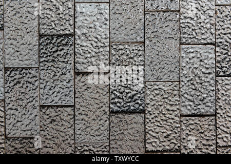Abstract background of textured black and white shiny ceramic tiles. Stock Photo