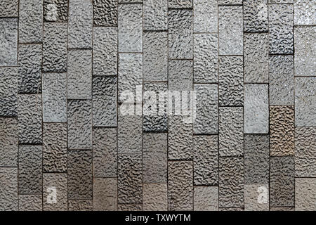Abstract background of textured black and white shiny ceramic tiles. Stock Photo