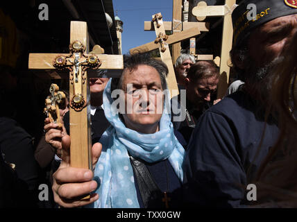 Orthodox Christians carry  wooden crosses during the Orthodox Good Friday procession on the Via Dolorosa, The Way of the Cross, in the Old Ctiy of Jerusalem, April 6, 2018. The Christians follow the path believed to be where Jesus Christ carried his cross to Calvary to be crucified.   Photo by Debbie Hill/UPI Stock Photo